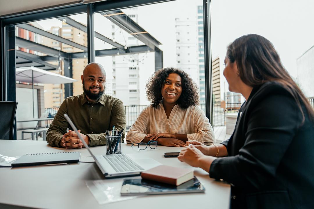 Three people talking in an office