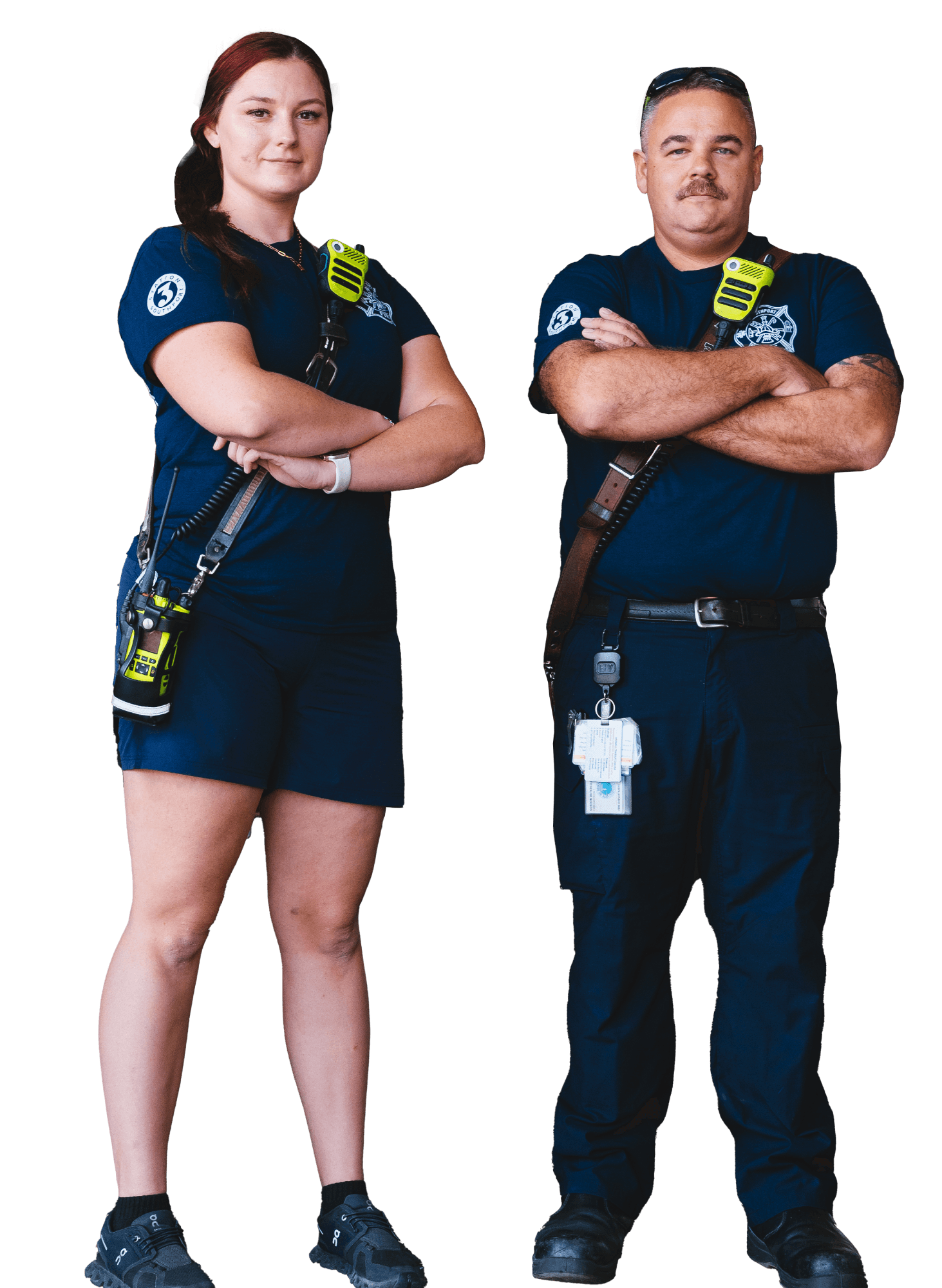 A woman and man firefighters standing next to each other with their arms crossed.